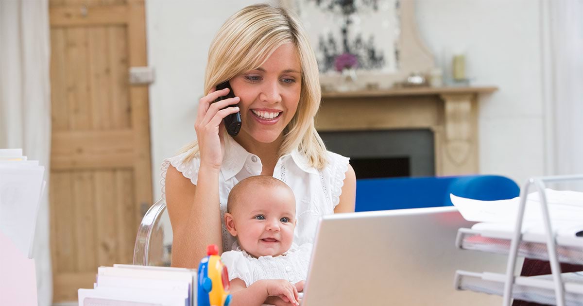 woman on cordless phone with baby on her lap