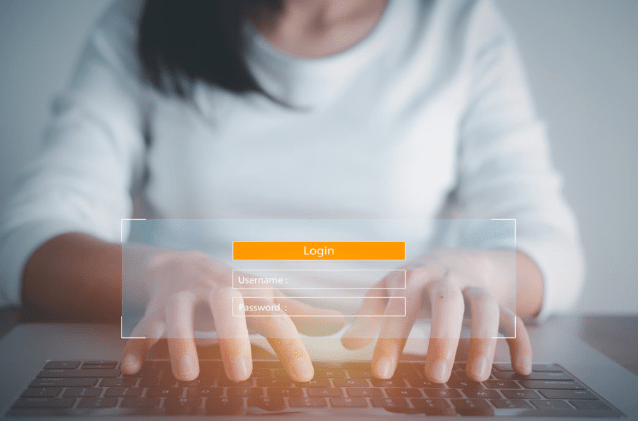 Person typing on keyboard with overlay of a login screen